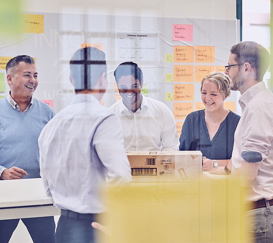 A group of people in business outfits standing together and talking to each other