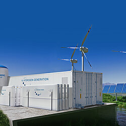 An industrial plant with wind turbines in the background