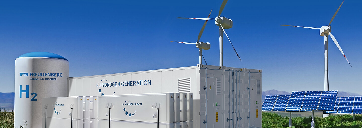 An industrial plant with wind turbines in the background